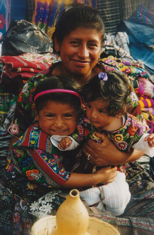 Guatemalan Woman and her Daughters Wearing Traditional Mayan Clothing