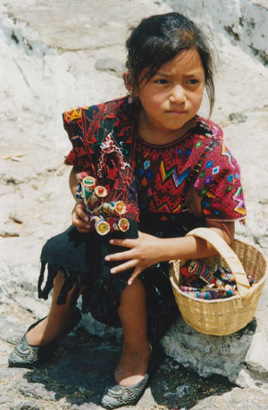Little Girl Wearing Traditional Mayan Dress Holding Worry Dolls