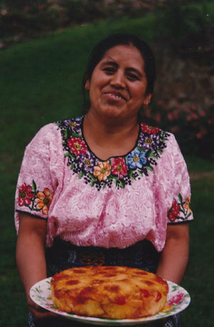 Maria Wearing a Huipil and Holding Pineapple Cake
